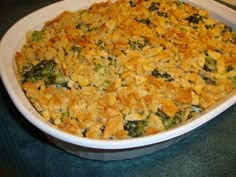 a casserole dish with broccoli and cheese in it on a table