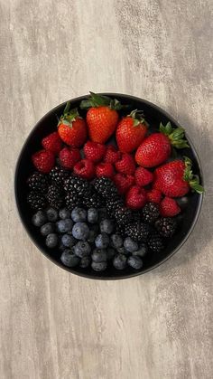 berries, blueberries and strawberries in a black bowl