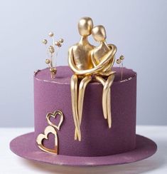 a purple hat with gold decorations on it and a couple sitting on top of it