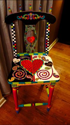 a colorful chair sitting on top of a hard wood floor