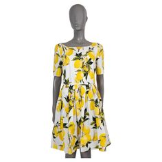 100% authentic Dolce & Gabbana poplin dress white cotton (100%) with lemon print in yellow and green. Features a round neck, short sleeves and pleated skirt. Opens with a concealed zipper in the back and is lined in cotton (100%). Has been worn and is in excellent condition. 2016 Spring/Summer Measurements Model F6VU6T FS5XY Tag Size 46 Size XXL Shoulder Width 39cm (15.2in) Bust From 96cm (37.4in) Waist From 78cm (30.4in) Hips From 118cm (46in) Length 84cm (32.8in) Side Seam Length 77cm (30in) S White Short Sleeve Dress With Lemon Print, White Short Sleeve Lemon Print Dress, Cotton Lemon Print Dress For Garden Party, Fitted Short Sleeve Dress With Lemon Print, Casual Short Sleeve Lemon Print Dress, Sheer Sleeve Dress, Silk Coat, White Cotton Dress, Boucle Jacket