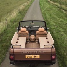 the back end of a car parked on a country road