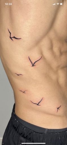 a man's stomach with birds on it