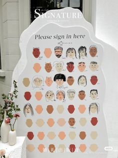 there is a sign that says please sign in here with many different faces on it