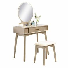 a vanity table with a stool and mirror on the top, next to it is a white flower vase