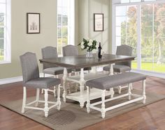 a dining room table with chairs and a bench