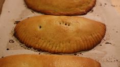 three pastries sitting on top of parchment paper