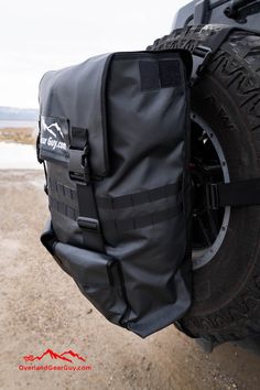 the back end of a truck with its cargo bag on it's tire compartment