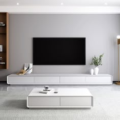 modern living room with white furniture and large flat screen tv mounted on the wall above coffee table