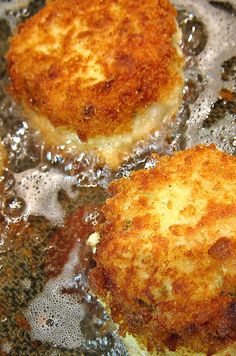 some food is cooking in a frying pan on the stove top and it appears to be fried