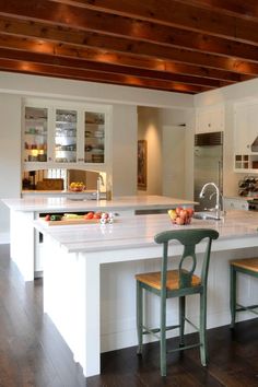 a kitchen with an island and two stools