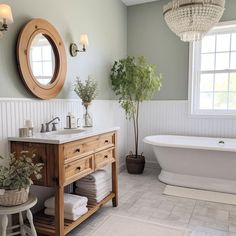 a bathroom with a tub, sink and mirror in it's centerpieces