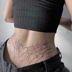 a woman with tattoos on her lower back