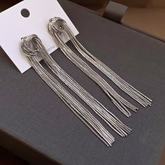 Fashion Element: Line Style: Affordable luxury style Silver Metal Tassel Drop Earrings, Elegant Metal Tassel Drop Earrings, Trendy Silver Dangle Tassel Earrings, Trendy Silver Tassel Earrings For Party, Silver Tassel Earrings For Party, Silver Trendy Tassel Earrings For Party, Trendy Silver Tassel Drop Earrings, Trendy Metal Tassel Earrings For Party, Chic Silver Tassel Earrings