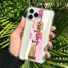 a woman holding up her phone case with the words, wine and flowers on it