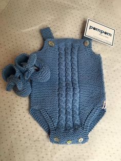 a blue knitted baby bodysuit with an elephant on it