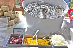 an assortment of food is displayed on a table with other foods and condiments