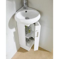 a white sink sitting under a bathroom mirror