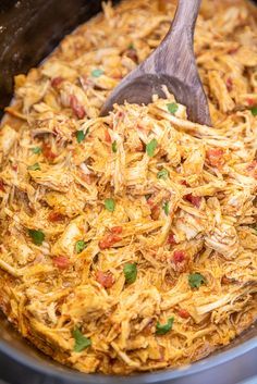 a slow cooker filled with shredded chicken and vegetables