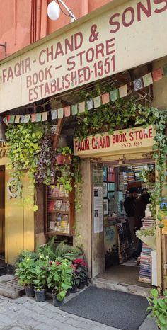 a store front with plants and books on display