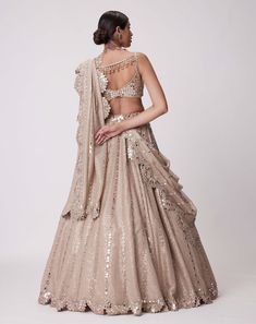 Step into glamour with the light beige sequin-embroidered lehenga and dupatta ensemble. Adorned with delicate sequin embroidery both the lehenga and dupatta radiate elegance. Paired with a sleeveless blouse featuring real hand-cut mirror embroidery this ensemble exudes sophistication and charm perfect for any special occasion where you want to shine. Beige Lehenga, Sequins Lehenga, Sequin Lehenga, Mirror Work Lehenga, Mirror Embroidery, Embroidered Lehenga, Indian Wedding Wear, Sequin Embroidery, Ethnic Outfits