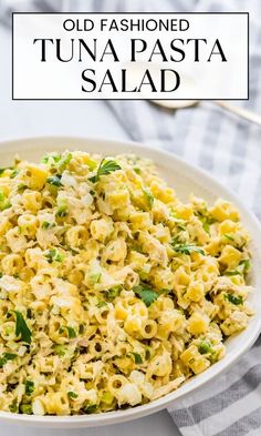 an old fashioned tuna pasta salad in a white bowl on a striped tablecloth with text overlay