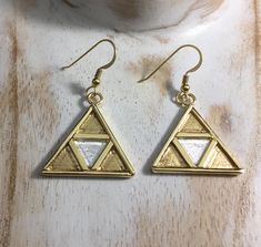 I've fabricated these unique sterling silver and 24K gold-plated Legend of Zelda inspired TriForce earrings. These are substantial and have some weight, though not so much to weigh down the earlobes. These are 1 inch in diameter and a lovely, unique keepsake for those who enjoy everything Zelda! Please feel free to convo if you have any questions and I'll answer quickly. Allow 3 days for fabrication prior to shipment. Thanks for looking! Triforce Earrings, Zelda Earrings, Earrings Diy, Felt Bag, Moon Pendant, Handmade Artisan, Diy Earrings, Legend Of Zelda, Christmas Ideas