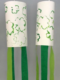 two lamps with green and white designs on them, one is made out of paper