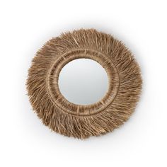 a round mirror made out of straw on a white background