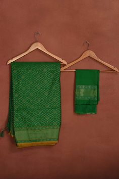 Radiate elegance on festive occasions in this beautiful green Katan silk Banarasi saree with over all zari work. The saree has yellow edging. It comes with a matching blouse piece. Disclaimer: The shown stitched blouse on the model is for display purpose only. The saree comes with a matching blouse piece and finished with fall and piko Disclaimer: The actual product may vary slightly from the image. These are custom orders, hence expect slight variation in color, placement of the motif or buta. Green Paithani Silk Traditional Wear With Zari Weaving, Green Traditional Wear With Zari Weaving In Paithani Silk, Green Semi-stitched Paithani Silk Saree, Semi-stitched Green Paithani Silk Saree, Green Tussar Silk Traditional Wear, Traditional Dark Green Dupatta With Cutdana, Dark Green Pallu Dupatta For Diwali, Green Self-design Dupatta For Puja, Green Banarasi Silk Traditional Wear With Zari Weaving