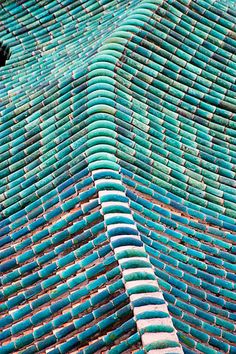 rows of blue chairs stacked on top of each other in the middle of an outdoor area