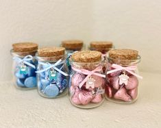 small glass jars filled with different types of candies