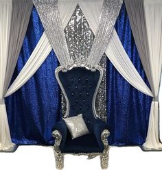 a blue and white stage set up with silver sequins on the back of it