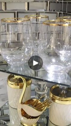 the table has many glasses on it and gold trimmings in front of them