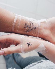 two people with matching tattoos on their arms