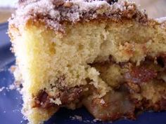 a close up of a piece of cake on a plate with some powdered sugar