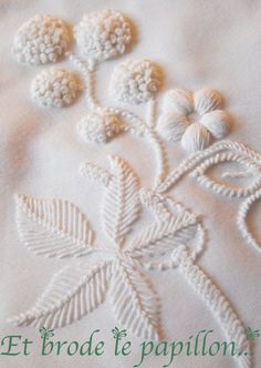 an embroidered piece of cloth with flowers on it