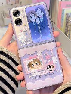 someone is holding up their phone case with anime characters on the front and back sides