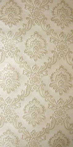 a white wallpaper with an ornate design on it