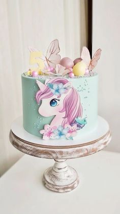 there is a cake decorated with an image of a unicorn on it