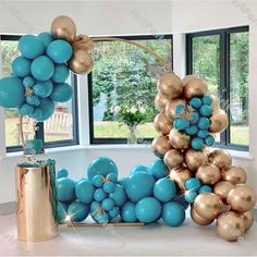 a balloon arch with blue and gold balloons