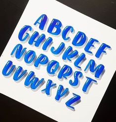 the upper and lower letters are cut out of paper with blue tape on top of them