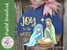 a christmas ornament with the words joy to the world on it and a nativity scene