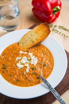 a white plate topped with soup and bread