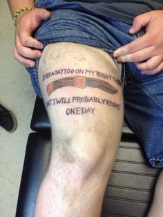 a man sitting in a chair with his legs crossed and tattoos on his leg that says,