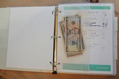 an open binder with money on it