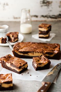 several pieces of dessert sitting on top of a cutting board