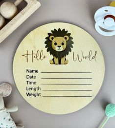 a baby's name tag with a lion on it next to toys and other items