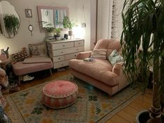 a living room filled with furniture and plants