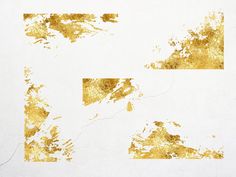 gold paint splattered on white paper with different shapes and sizes in the middle